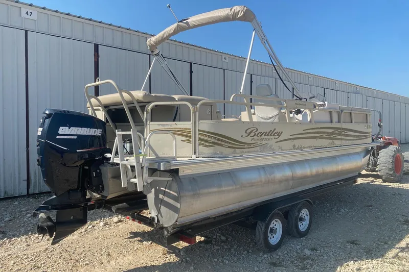 Slide: The Image of 2008 Bentley Pontoons Prestige 223LC with Evinrude motor, parked on a trailer. - 5