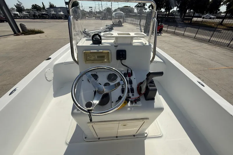 Slide: The Image of 2008 Champion 220 Bay boat console with steering wheel and controls. - 14