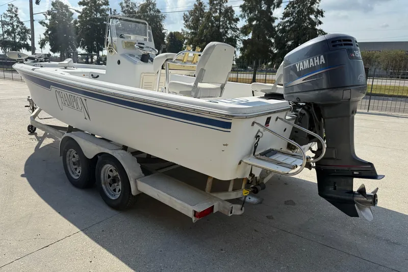 Slide: The Image of 2008 Champion 220 Bay boat with Yamaha outboard motor on a trailer. - 5