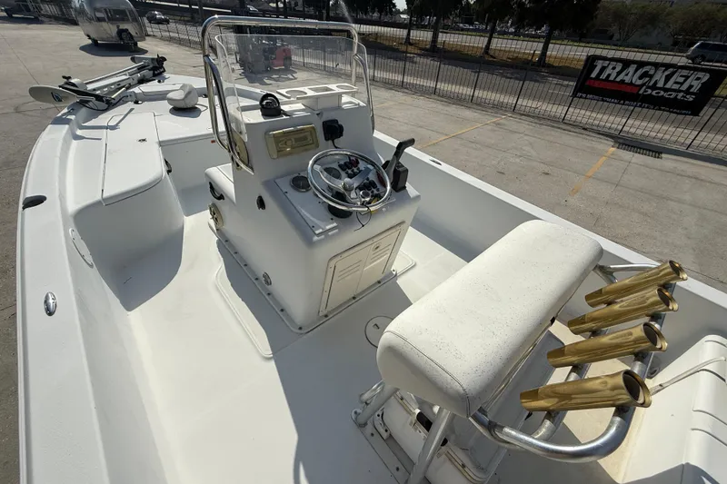 Slide: The Image of 2008 Champion 220 Bay boat interior with console, seating, and rod holders. - 9