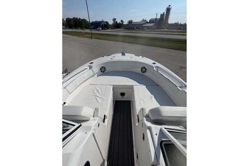 Slide: The Image of 2023 Edgewater 248 CX boat interior with white seating and open deck view. - 10