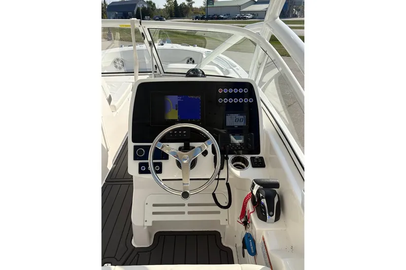 Slide: The Image of 2023 Edgewater 248 CX boat helm with modern controls and navigation display. - 11