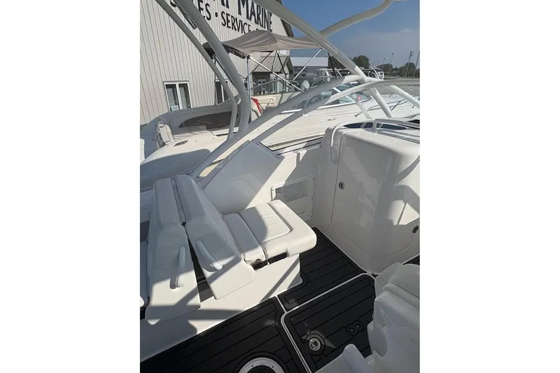Slide: The Image of 2023 Edgewater 248 CX boat interior with white seating and sleek design. - 13