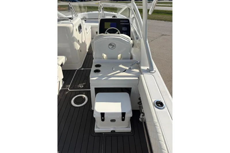 Slide: The Image of 2023 Edgewater 248 CX boat interior with helm, seating, and modern controls. - 18