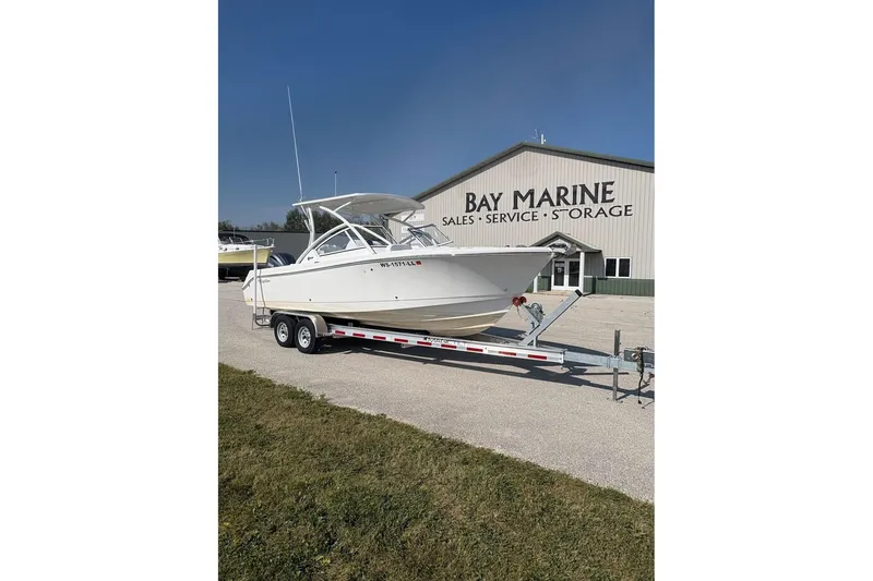 Slide: The Image of 2023 Edgewater 248 CX boat on trailer at Bay Marine dealership. - 4