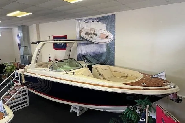 Slide: The Image of 2025 Chris-Craft Launch 28 GT boat displayed indoors, featuring elegant design and luxurious seating. - 3