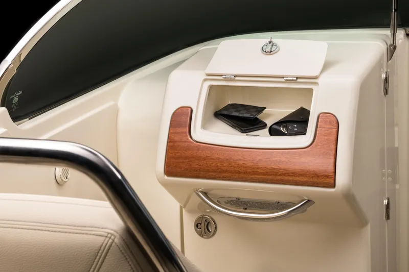 Slide: The Image of 2024 Chris-Craft Launch 28 GT dashboard storage compartment with wooden trim. - 6