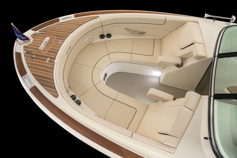 Slide: The Image of 2024 Chris-Craft Launch 28 GT boat interior with luxurious seating and teak wood accents. - 8