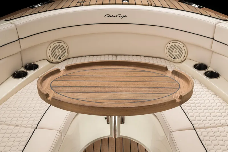 Slide: The Image of 2024 Chris-Craft Launch 28 GT interior with wooden table and cushioned seating. - 9