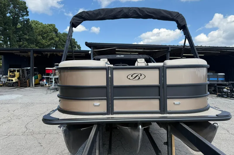 Slide: The Image of 2025 Bentley Pontoons Legacy 223 QSB pontoon boat in storage yard, front view. - 1