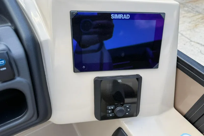Slide: The Image of Simrad and JBL displays on 2025 Bentley Pontoons Legacy 223 QSB dashboard. - 10