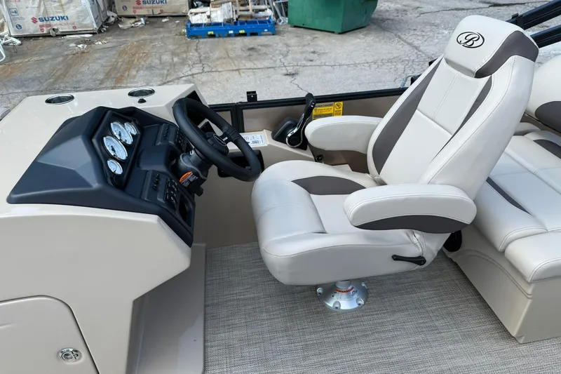 Slide: The Image of 2025 Bentley Pontoons Legacy 223 QSB helm with luxurious captain's chair and dashboard. - 8
