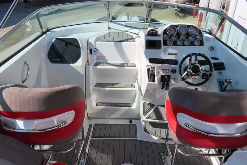 Slide: The Image of Interior of a 2008 Baja 335 Performance boat with modern dashboard and seating. - 13