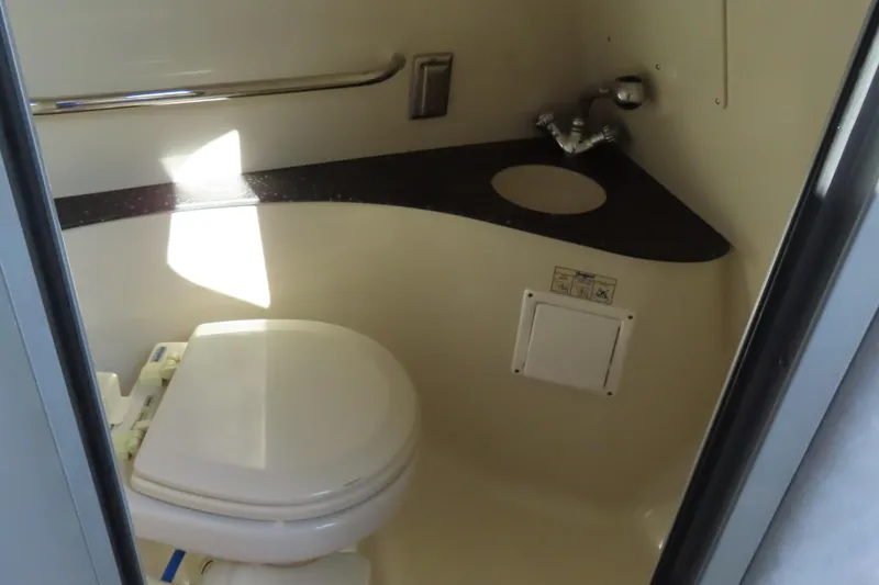 Slide: The Image of Compact bathroom in 2008 Baja 335 Performance boat with toilet and sink. - 17