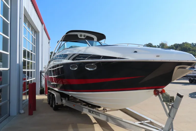 Slide: The Image of 2008 Baja 335 Performance boat on trailer near a building, sunny day. - 4