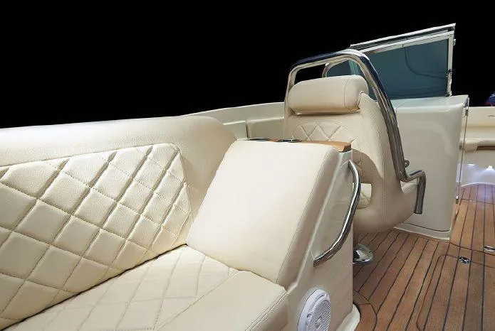 Slide: The Image of 2024 Chris-Craft Launch 27 interior with beige diamond-stitched seating and storage compartment. - 12