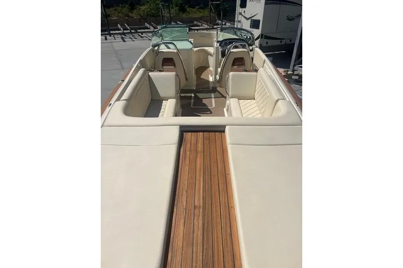 Slide: The Image of 2024 Chris-Craft Launch 27 boat interior with beige seating and wood accents. - 7