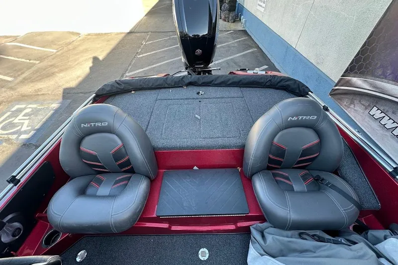 Slide: The Image of 2024 Nitro Z17 boat interior with dual gray seats and red accents. - 12