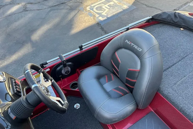 Slide: The Image of 2024 Nitro Z17 boat interior with steering wheel and branded seat. - 13