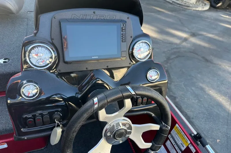 Slide: The Image of 2024 Nitro Z17 boat dashboard with steering wheel and digital display. - 14