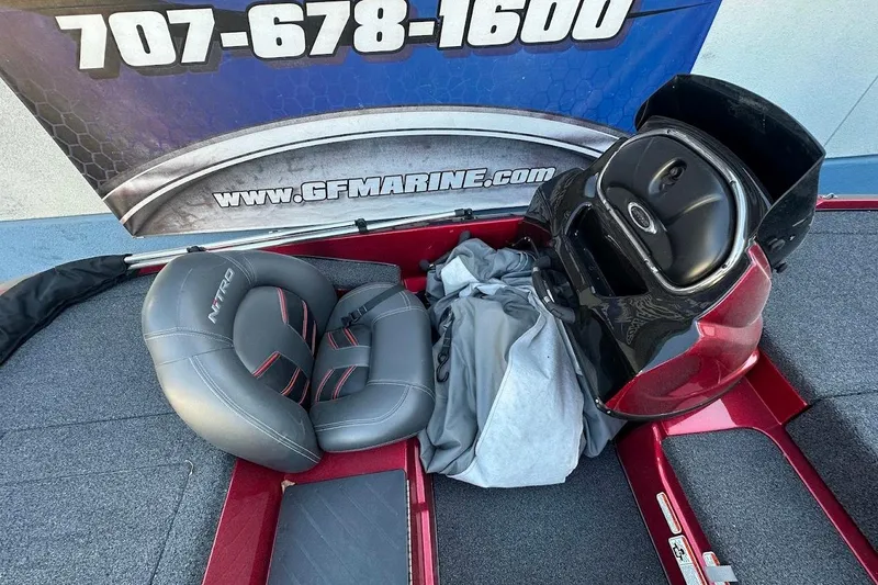 Slide: The Image of 2024 Nitro Z17 boat interior with gray seats and red accents. - 16