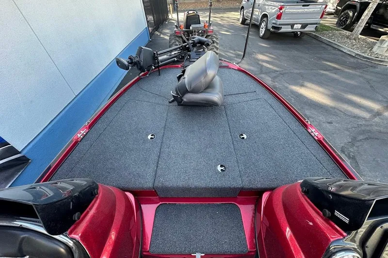 Slide: The Image of 2024 Nitro Z17 boat with spacious deck and seating, parked outdoors. - 18