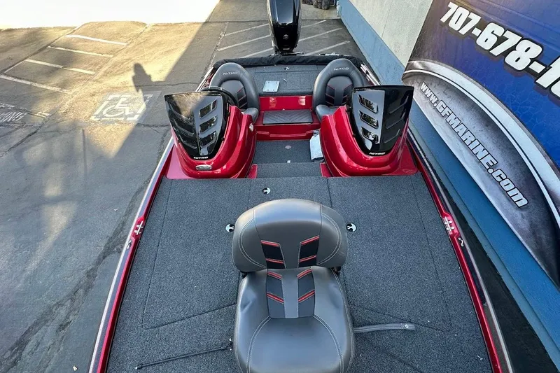 Slide: The Image of 2024 Nitro Z17 boat interior with seating and control panels, parked near a building. - 20