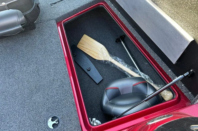 Slide: The Image of 2024 Nitro Z17 storage compartment with paddle and seat, featuring red trim. - 23