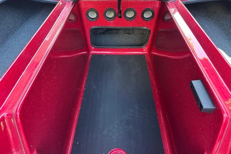 Slide: The Image of Red interior compartment of 2024 Nitro Z17 boat, featuring circular vents. - 24