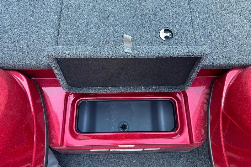 Slide: The Image of 2024 Nitro Z17 boat storage compartment with open lid, featuring red and gray design. - 25