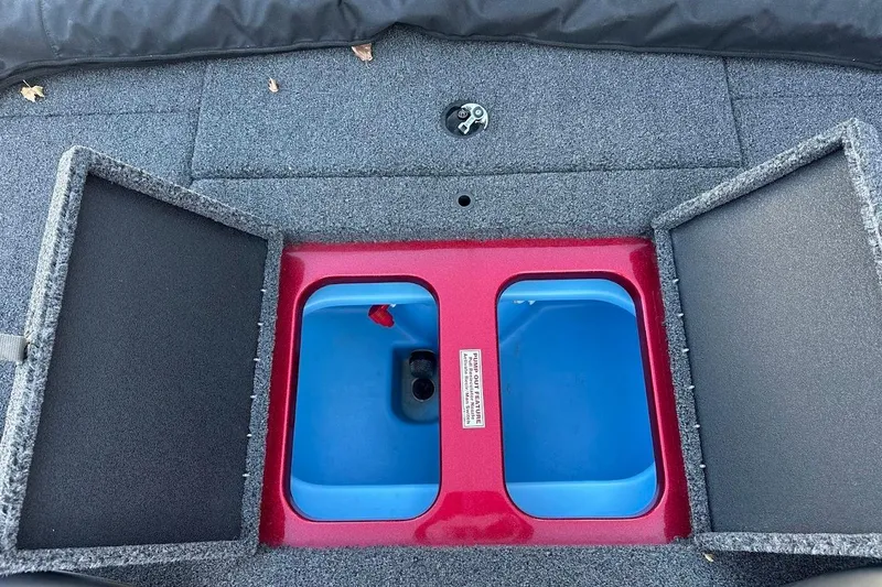 Slide: The Image of 2024 Nitro Z17 boat storage compartment with open lids, featuring a blue interior. - 26