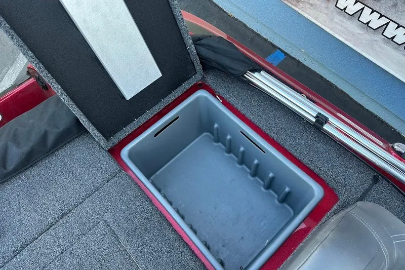 Slide: The Image of Open storage compartment in 2024 Nitro Z17 boat, featuring carpeted interior and sleek design. - 27