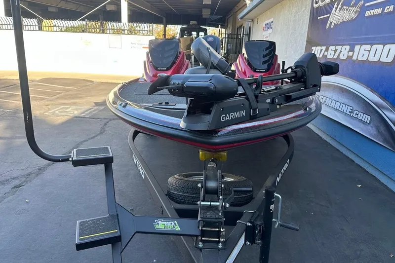 Slide: The Image of 2024 Nitro Z17 boat with Garmin equipment on trailer in parking lot. - 4