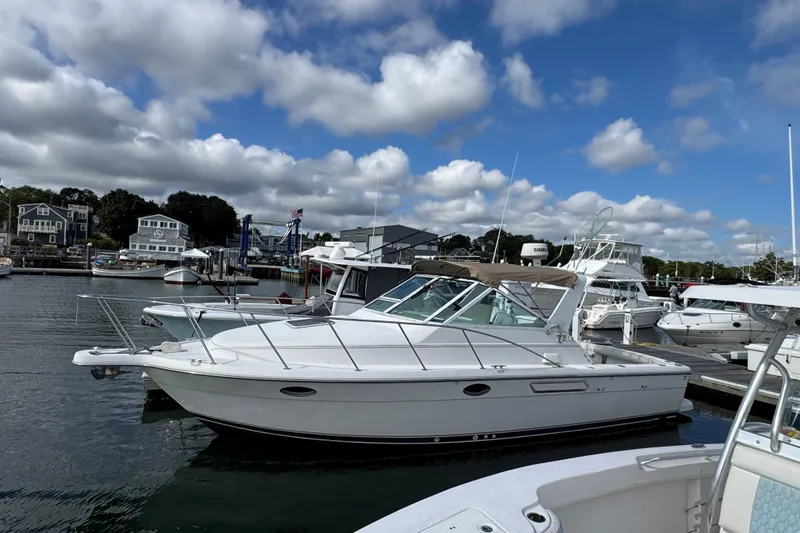 The Image of 1999 Tiara Yachts 2900 Open docked at a marina under a partly cloudy sky. - 0