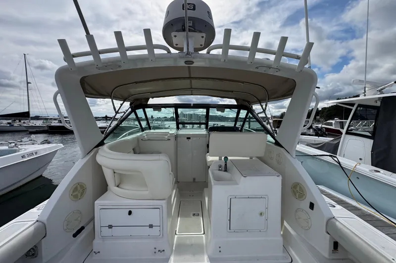 Slide: The Image of 1999 Tiara Yachts 2900 Open boat interior at marina, featuring helm and seating area. - 11