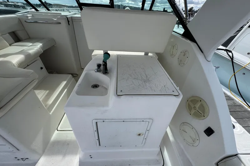 Slide: The Image of 1999 Tiara Yachts 2900 Open interior with seating and utility area. - 12