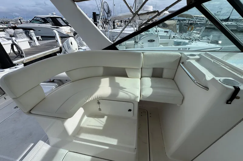 Slide: The Image of 1999 Tiara Yachts 2900 Open interior seating area at a marina. - 13