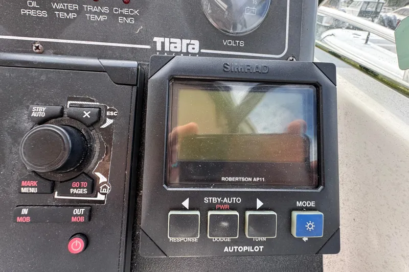 Slide: The Image of Control panel of a 1999 Tiara Yachts 2900 Open with Simrad autopilot display. - 18