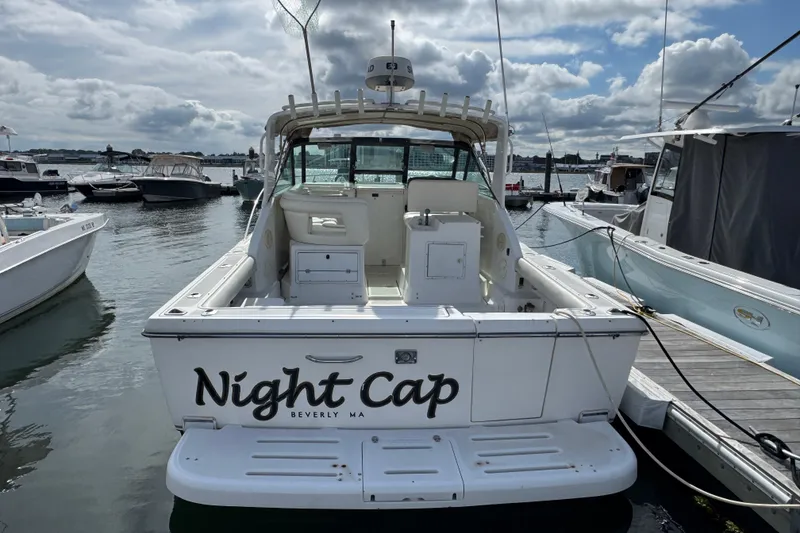 Slide: The Image of 1999 Tiara Yachts 2900 Open boat named "Night Cap" docked in marina. - 2
