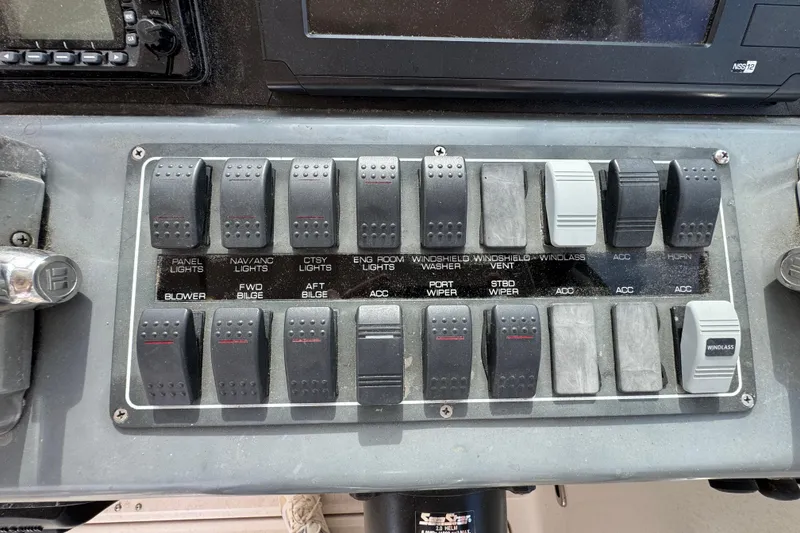 Slide: The Image of Control panel of a 1999 Tiara Yachts 2900 Open with labeled switches. - 21