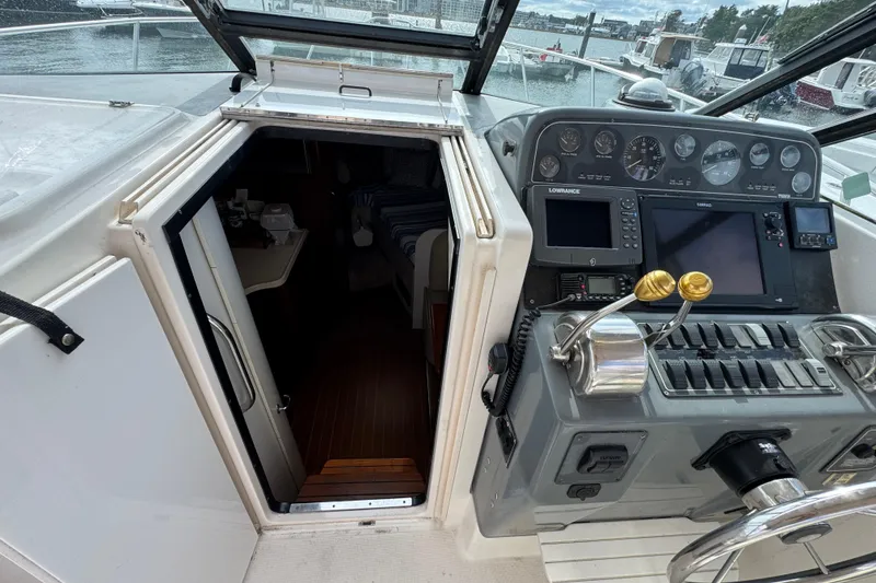 Slide: The Image of 1999 Tiara Yachts 2900 Open cockpit with navigation controls and cabin entrance. - 24