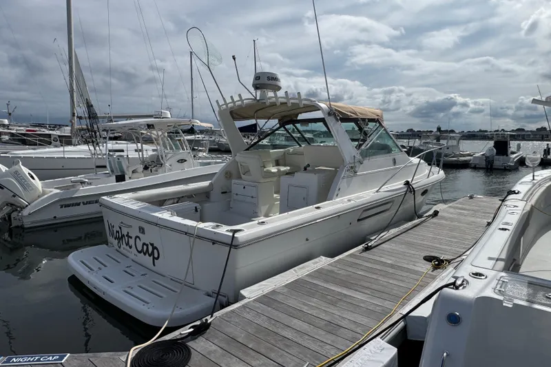 Slide: The Image of 1999 Tiara Yachts 2900 Open docked at marina under cloudy sky. - 3