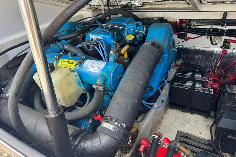 Slide: The Image of Engine compartment of a 1999 Tiara Yachts 2900 Open, featuring blue engine components. - 33