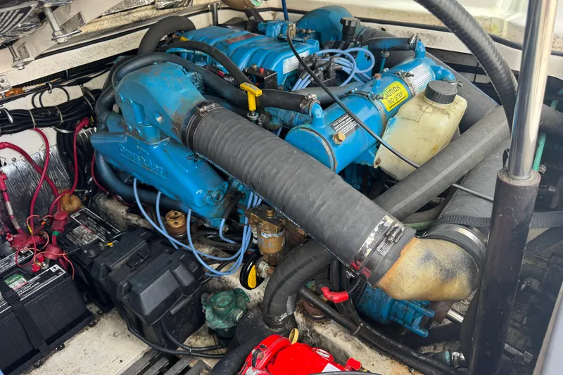 Slide: The Image of Engine compartment of a 1999 Tiara Yachts 2900 Open, featuring blue engine components. - 34