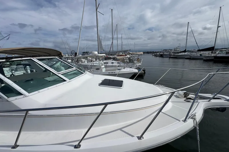 Slide: The Image of 1999 Tiara Yachts 2900 Open docked in a marina with other boats. - 5