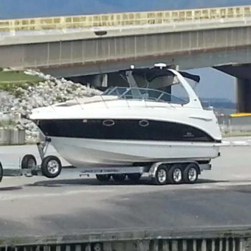 The Image of 2006 Chaparral Signature 290 boat on a trailer near a bridge. - 0