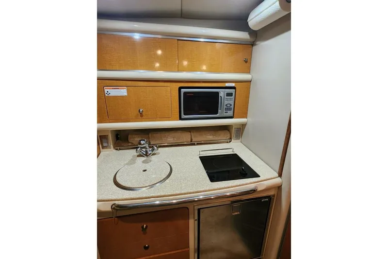 Slide: The Image of 2006 Chaparral Signature 290 interior with cozy seating, kitchenette, and sleeping area. - 17