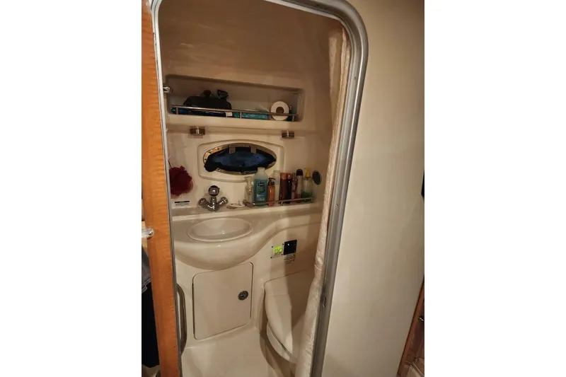 Slide: The Image of 2006 Chaparral Signature 290 boat bathroom with sink, mirror, and storage. - 19