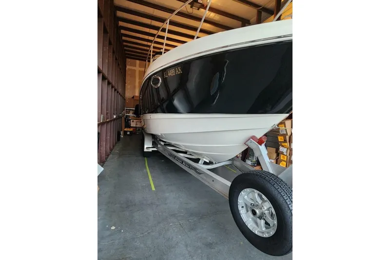 Slide: The Image of 2006 Chaparral Signature 290 boat interior with seating, table, and helm in storage. - 2