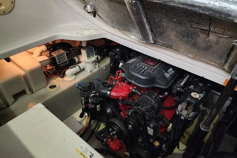 Slide: The Image of Engine compartment of 2006 Chaparral Signature 290 boat, featuring dual engines and wiring. - 27